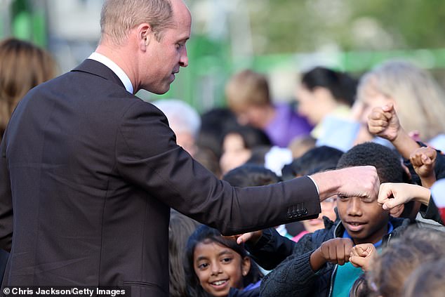 Prince William also greeted some schoolchildren queuing to meet him with a fist bump