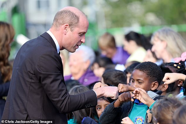 Schoolchildren lined up to fist bump the heir to the throne as he arrived at the Grange Pavilion in Cardiff