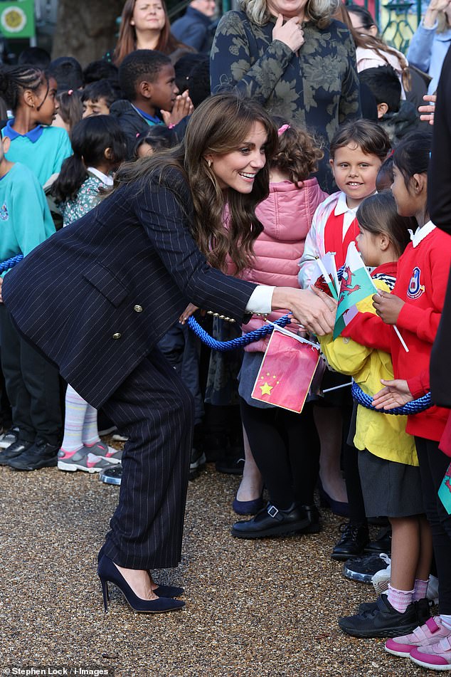 After a while, Princess Kate ditched the fist bumps and shook hands with some young royal fans