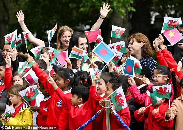 Schoolchildren waving Welsh flags, as well as flags from other countries around the world, including India, were on hand to greet the royals