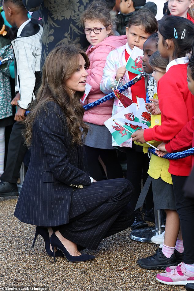 Princess Kate crouched down to chat to the young schoolchildren who had gathered to meet her at the Grange Pavilion