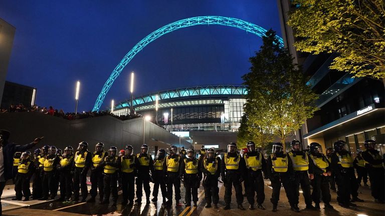 Police form a cordon around Wembley Stadium after it was breached by ticketless supporters ahead of the Euro 2020 final between England and Italy in July 2021