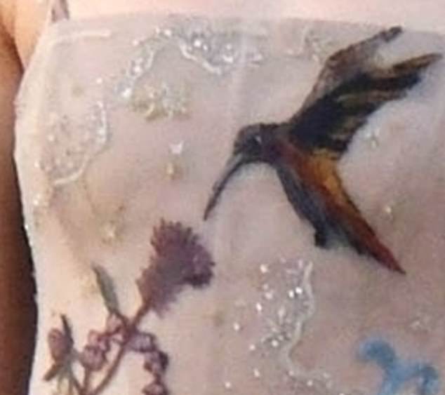 Lovebird: A caramel-colored hummingbird is the main embroidered detail on the corseted bodice of the dress;  the bird can mean happiness, beauty, healing and love