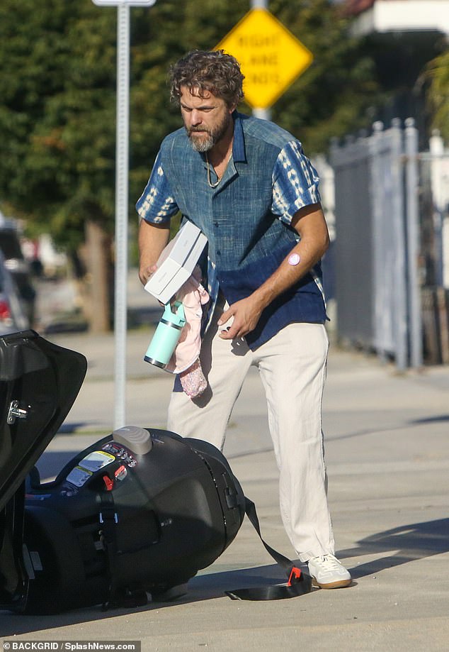 Duties of the father: The star loaded clothes and a bottle of water into his car