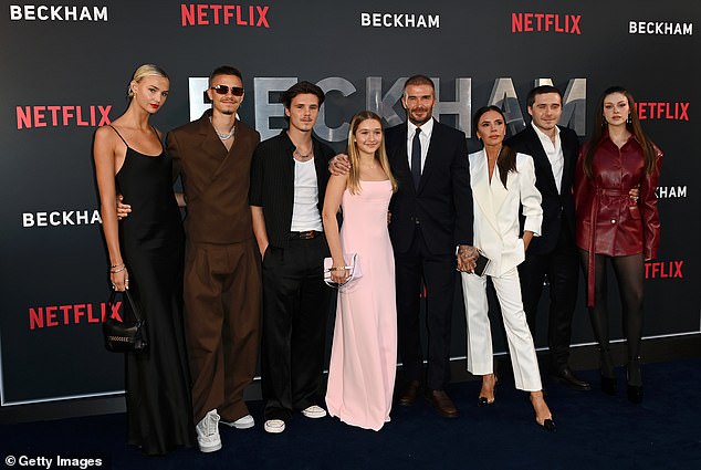 Say cheese: The whole family and their respective wives and girlfriends were at London's O2 Arena for the premiere of BECKHAM (from left to right: Mia Regan, Romeo Beckham, Cruz Beckham, Harper Beckham, David Beckham, Victoria Beckham, Brooklyn Beckham and Nicola Peltz)