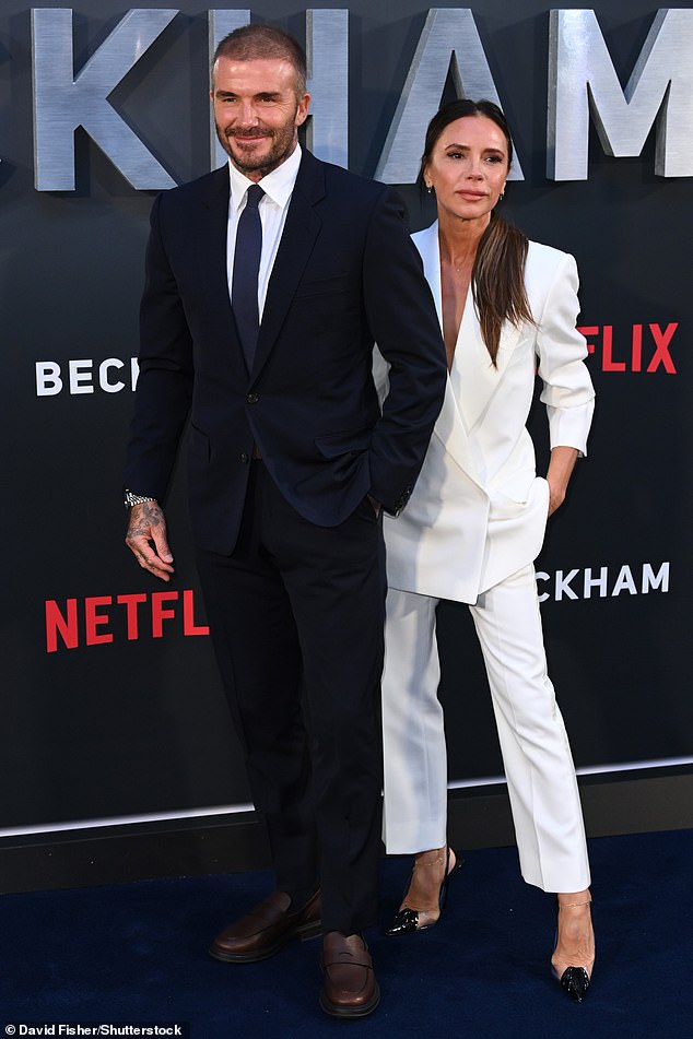 Looking good: To celebrate the show's release, Victoria Beckham put on a very smart display in a white suit as she stepped out alongside her former footballer husband at the premiere