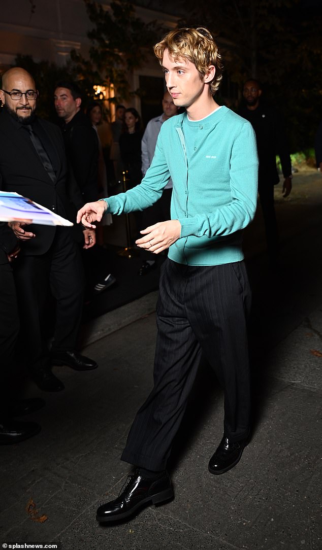 Clear: Troye Sivan wore a blue sweater and smart pants