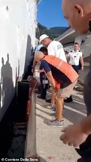 Father can be seen trapped meters deep in water as concerned onlookers gather around him to help him