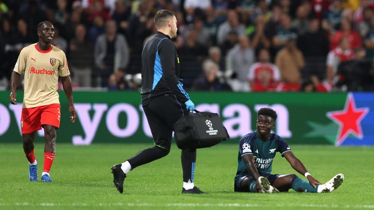 Bukayo Saka awaits treatment before heading off in Arsenal's 2-1 defeat to Lens