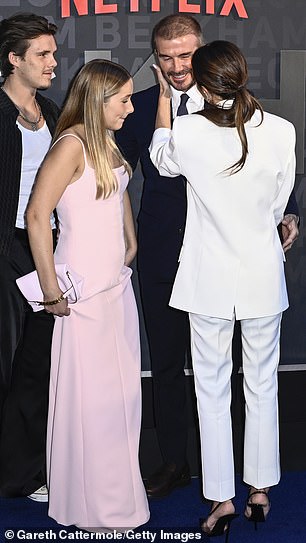 Inseparable: Victoria was seen caressing her husband's face as they posed for photos on the blue carpet