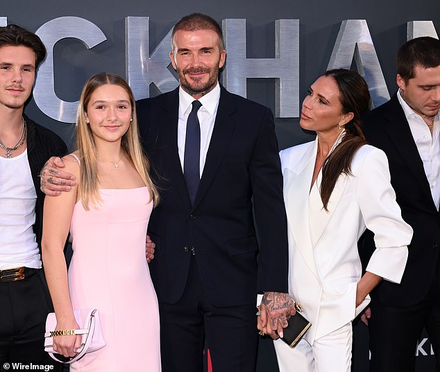 The look of love: Victoria gave her husband an admiring look as they posed with their children at the event