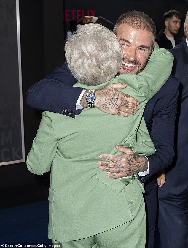 There you go: Beckham leaned in to welcome a loving hug from his mother at the O2 Arena on Tuesday night