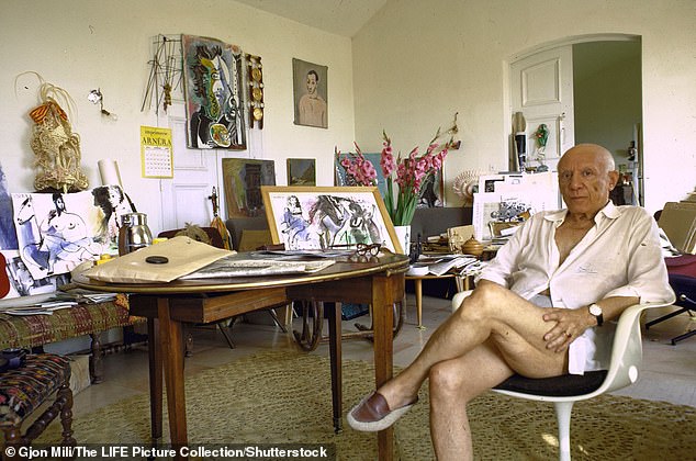 The famous artist pictured in his home in France, surrounded by his artwork