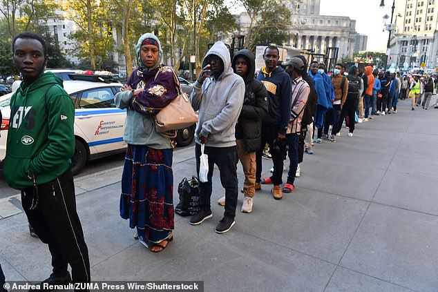 Migrants streaming into NYC line up to enter Federal Plaza to file with immigration authorities on Monday