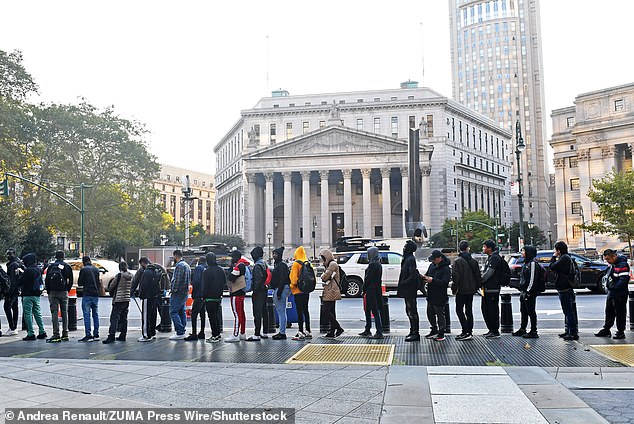 The line of migrants formed across the street from 60 Center Street, where the civil fraud trial of Donald Trump is taking place