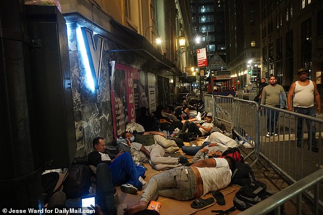 People sleep on the sidewalk outside the Roosevelt Hotel in August.  Officials said Tuesday that the Roosevelt currently has 412 people waiting for shelter