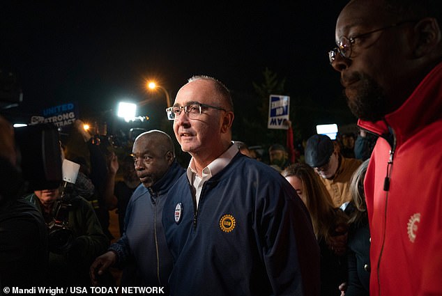 UAW President Shawn Fain (center) organized the historic strike in an effort to keep companies in the dark about what might happen next and encourage deal-making