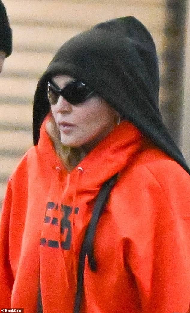 Incognito: The 65-year-old Queen of Pop protected her makeup-free complexion under $585 Balenciaga 'Fennec Oval Sunglasses' and a $2,041 Vetements limited edition 'Hooded Bomber Jacket'