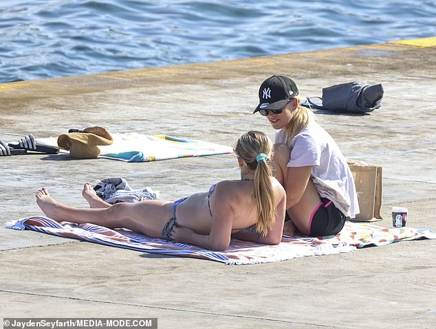 Jackie and her daughter later dried off on the concrete slab by the water, enjoying the sun while Kitty enjoyed the school holidays