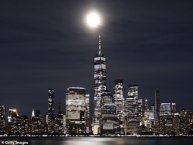 The skyline of Lower Manhattan can be seen under the Blue Supermoon in August