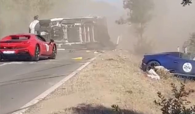 But seconds later the red Ferrari behind it can be seen trying to overtake at the same time, causing the Lamborghini to end up underneath the camper, which is then violently tipped on its side.