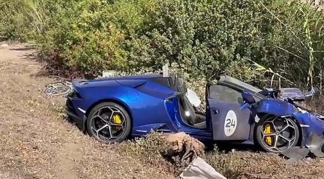 The blue Lamborghini is badly damaged on the side of the road