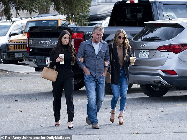 Mallory and Macy Morphew flank their father as they walk into court following his arrest for their mother's murder.  The charges were eventually dropped and his daughters continue to believe in his innocence