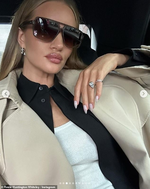 Shady lady: she posed in a car for a close-up photo, showing off her pear-shaped diamond ring, matching earrings and oversized sunglasses