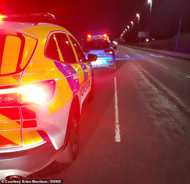 Police stop Mr Morrison's car after the terrifying incident in Glasgow.  A police car can be seen at the back and another van at the front