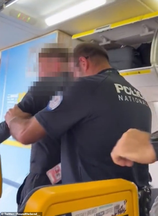 Passengers – and at one point even an officer – cheered as the man was removed from the plane