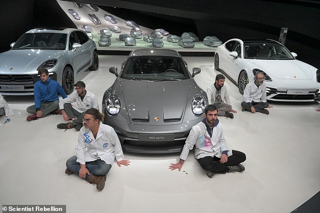 A group of eco-activists taped themselves to the floor of a Porsche showroom in Germany and vowed to stay there until their demands to decarbonize Germany's transport sector were met