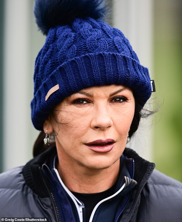 Cozy: the actress, 53, dressed in a blue quilted jacket, paired with jeans and a knitted pompom hat