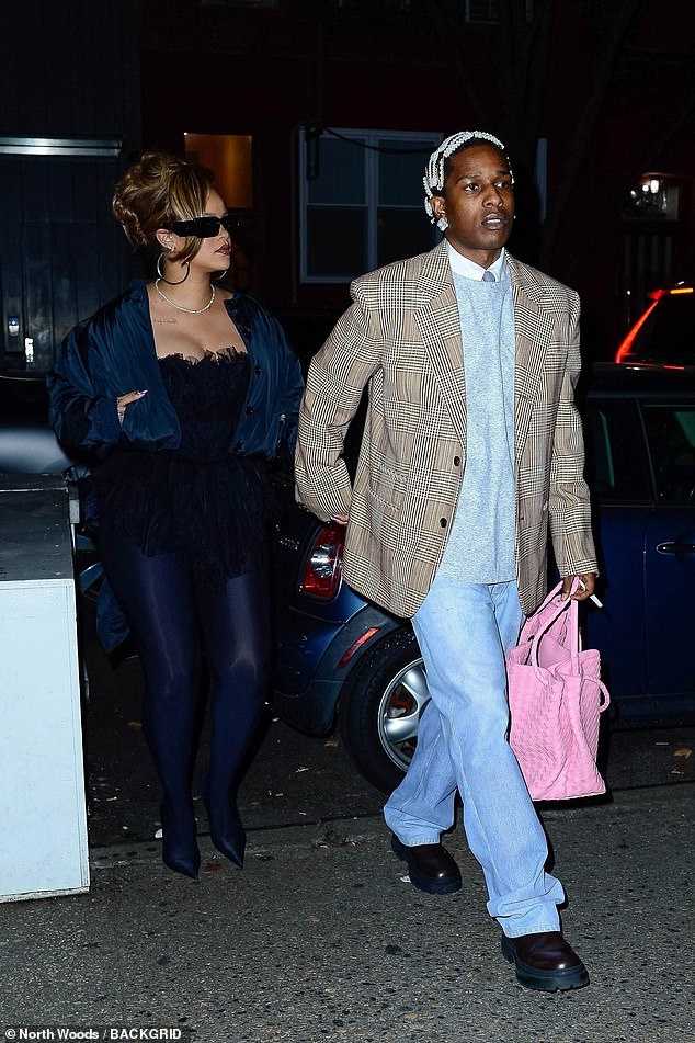 Holding hands: ASAP smoked a rolled cigarette while walking next to Rihanna