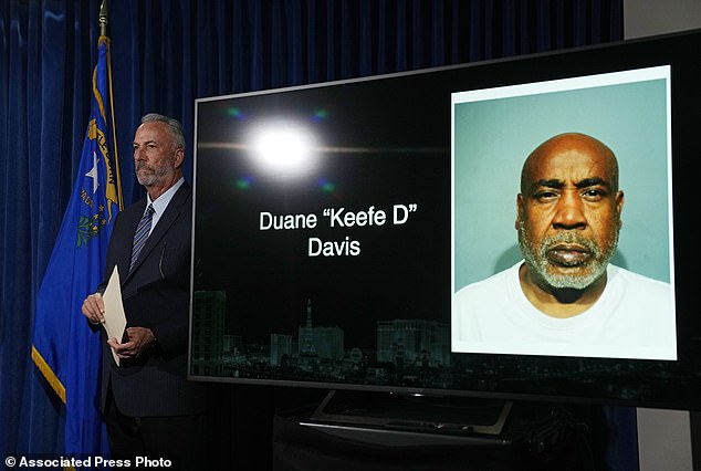 Clark County District Attorney Steve Wolfson stands next to a photo of Duane 