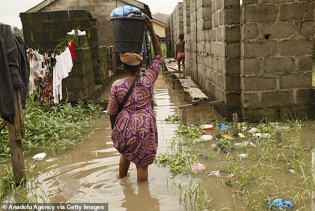 Images of citizens dealing with flooding are becoming the norm.  Pictured: A flooded street in Lagos, Nigeria in September 2023