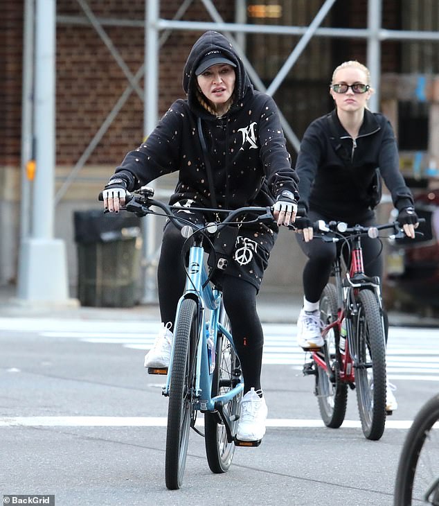 Days away: The Like A Prayer hitmaker, who is recovering from a bacterial infection that left her hospitalized, wore a black hoodie and baseball cap, teamed with matching shorts and leggings as she cycled