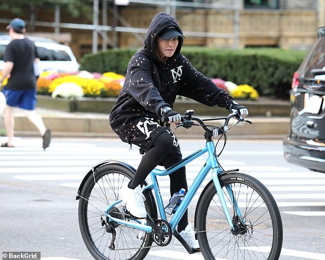 Here she goes: She wore fingerless gloves and completed the ensemble with white sneakers