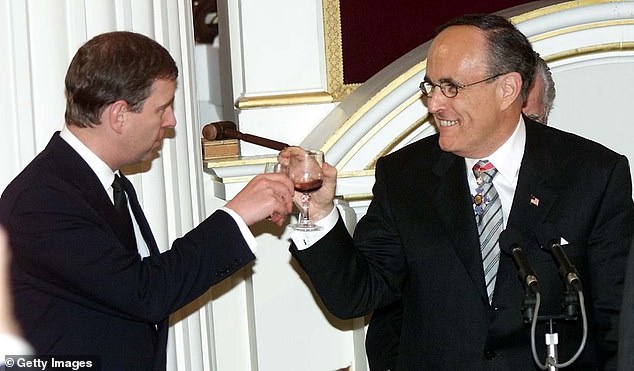 Giulaini toasts with Prince Andrew in February 2002 after receiving an honorary knighthood