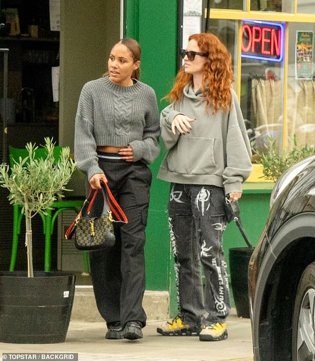 Cool: Alex looked effortlessly stylish in a cropped gray sweater and black cargo pants, while Jess opted for an oversized hoodie and dark jeans