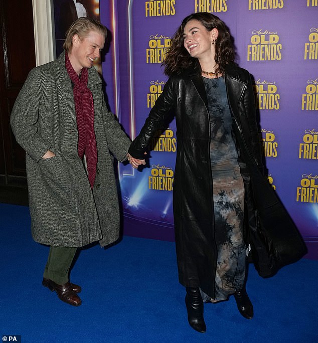 Lily James, 34, took Freddie's hand as they arrived at the Gielgud Theater in the West End for the first night of Stephen Sondheim's Old Friends