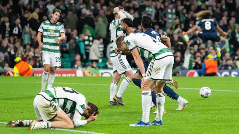 Celtic players fall dejectedly to the ground after Lazio's late winner