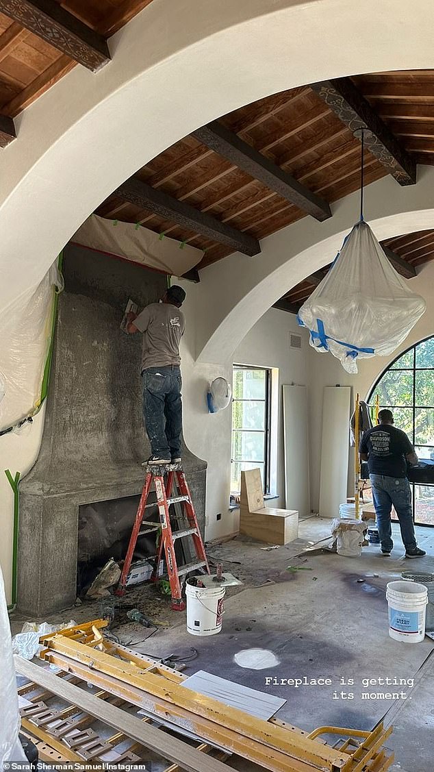 Busy: Workers were seen building a fireplace in the home