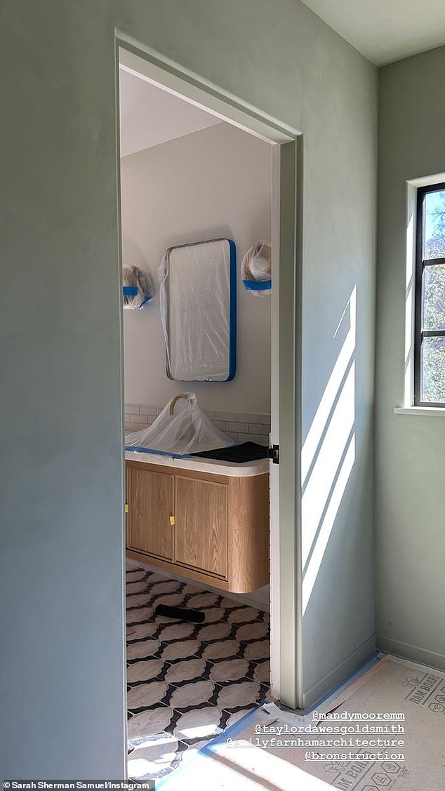 Almost done: A bathroom in Moore's home had protective plastic coverings over the mirrors and cabinets