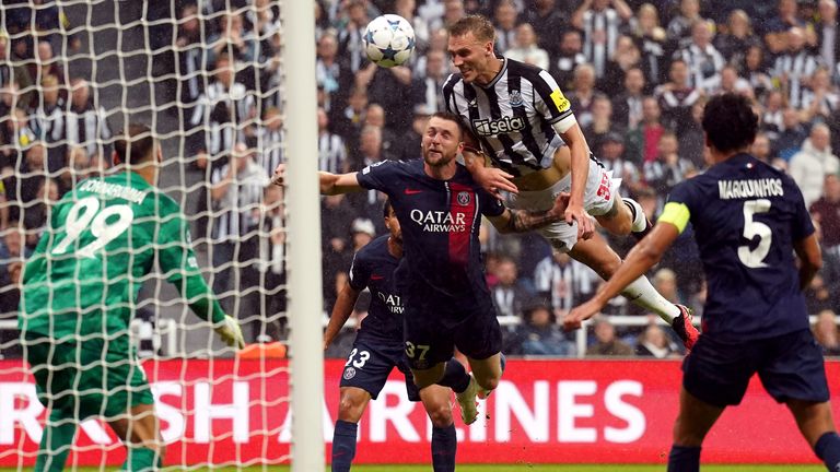 Dan Burn scores Newcastle's second goal against PSG