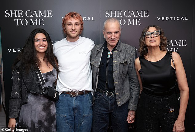 Family affair: The picture-perfect parents were also joined by their son Ronan, 25, who rocked a casual white T-shirt and jeans for the big debut;  seen with friend Lena Christakis on far left