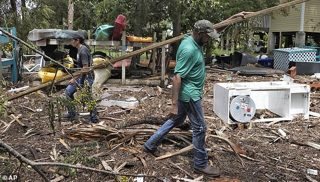 Entire towns were leveled by the hurricane, while residents of Cedar Key, Florida (pictured) were tasked with removing tornado debris