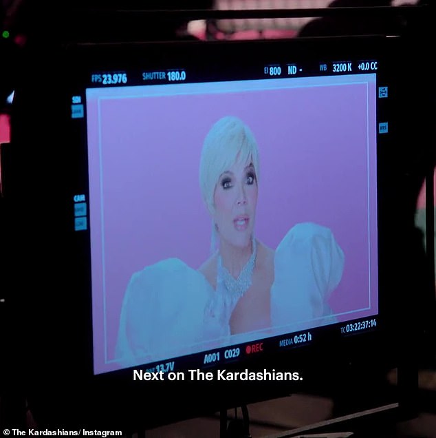 On set: Back in Los Angeles, Kris is on the set of Meghan Trainor's music video, with Kris dressed in an elaborate white dress with a diamond necklace and earrings