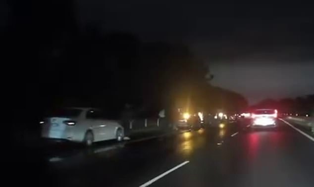 A driver who luckily escaped unscathed filmed dozens of cars parked along the left side of the highway, all with their hazard lights on and all with at least one flat tire