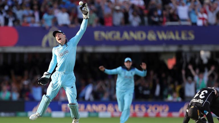 England's Jos Buttler celebrates after beating New Zealand's Martin Guptill in the Super Over in the 2019 Cricket World Cup final