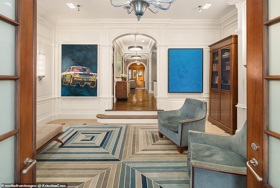 The entrance of the six-story house, located on the Upper East Side, provides access through French doors to a spacious foyer with a fireplace